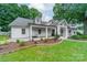 Charming white brick home with a covered porch, manicured landscaping, and a welcoming facade at 1121 S Wendover Rd, Charlotte, NC 28211