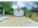 Detached two-car garage with white siding and ample driveway space at 1121 S Wendover Rd, Charlotte, NC 28211