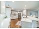 Bright kitchen featuring stainless steel appliances, white cabinets, counter seating, and hardwood floors at 1121 S Wendover Rd, Charlotte, NC 28211