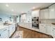 Bright kitchen with white cabinets, stainless steel appliances, and hardwood floors at 1121 S Wendover Rd, Charlotte, NC 28211