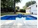 Sparkling pool with waterfall feature and patio, surrounded by mature trees and lush landscaping at 1121 S Wendover Rd, Charlotte, NC 28211