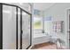 Modern bathroom featuring a glass-enclosed shower, a soaking tub, and bright, clean finishes at 1155 Rudder Cir, Salisbury, NC 28146