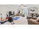 Well-lit bonus room showcasing a home entertainment setup, a comfortable seating area, and exercise equipment at 1155 Rudder Cir, Salisbury, NC 28146
