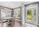 Bright dining room featuring a modern chandelier, large windows, and stylish furniture at 1155 Rudder Cir, Salisbury, NC 28146