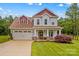 Charming two-story home featuring a landscaped yard, two-car garage and welcoming front porch at 1155 Rudder Cir, Salisbury, NC 28146