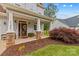 Inviting front porch featuring stone columns, rocking chairs, and a decorative wreath on the front door at 1155 Rudder Cir, Salisbury, NC 28146