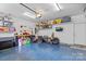 Spacious garage with blue epoxy floors, pegboard, shelving, and ample storage space at 1155 Rudder Cir, Salisbury, NC 28146