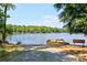 Lakeside view with boat ramp, bench, and lush trees at 1155 Rudder Cir, Salisbury, NC 28146