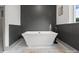 Luxurious bathroom featuring a freestanding tub with modern fixtures, set against stylish wall paneling for a spa-like ambiance at 120 Pinewood Ln, Rock Hill, SC 29730