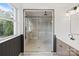 Elegant bathroom showcasing a modern glass-enclosed shower, complemented by stylish fixtures and a serene outdoor view at 120 Pinewood Ln, Rock Hill, SC 29730