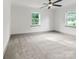 Spacious bedroom with neutral decor, featuring plush carpeting, natural light, and ample space for personalization at 120 Pinewood Ln, Rock Hill, SC 29730