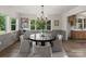 Bright dining area featuring a modern chandelier and views of the green outdoors at 120 Pinewood Ln, Rock Hill, SC 29730