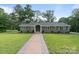 Charming single-story home with a well-manicured lawn and inviting walkway at 120 Pinewood Ln, Rock Hill, SC 29730