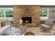 Inviting living room with a stone fireplace, neutral furnishings, and ample natural light, creating a cozy gathering space at 120 Pinewood Ln, Rock Hill, SC 29730