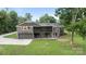 Two-story home with a screened porch and spacious backyard surrounded by mature trees at 120 Pinewood Ln, Rock Hill, SC 29730