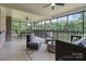 Inviting screened porch with comfortable seating, ceiling fan, and view of the lush backyard at 120 Pinewood Ln, Rock Hill, SC 29730