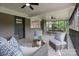 Inviting screened porch with comfortable seating, ceiling fan, and view of the lush backyard at 120 Pinewood Ln, Rock Hill, SC 29730