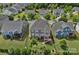 Aerial view of a home featuring a well-manicured lawn, fenced backyard, and wooden deck in a residential neighborhood at 12214 Bonny Oaks Dr, Cornelius, NC 28031