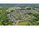 Expansive aerial view of a residential community with lush landscaping, mature trees, and well-maintained homes at 12214 Bonny Oaks Dr, Cornelius, NC 28031