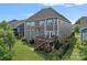 Charming two-story home featuring a wooden deck, well-maintained lawn, and fenced backyard, perfect for outdoor entertaining at 12214 Bonny Oaks Dr, Cornelius, NC 28031