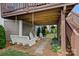 Relax under the deck with swing seating and chairs with a landscaped backyard for outdoor enjoyment at 12214 Bonny Oaks Dr, Cornelius, NC 28031