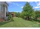 Expansive fenced backyard, featuring a well-maintained lawn and mature trees, perfect for outdoor activities at 12214 Bonny Oaks Dr, Cornelius, NC 28031
