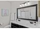 Clean, well-lit bathroom features a double sink vanity, modern fixtures and a large framed mirror at 12214 Bonny Oaks Dr, Cornelius, NC 28031