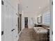 Bathroom boasts a soaking tub, separate shower, and walk in closet, complemented by tile floors at 12214 Bonny Oaks Dr, Cornelius, NC 28031