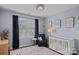 Cozy bedroom with a plush rug, inviting crib, and calming blue walls creates a serene and stylish space at 12214 Bonny Oaks Dr, Cornelius, NC 28031