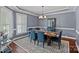 Elegant dining room with wainscoting, a modern chandelier, and a window for natural light, perfect for entertaining at 12214 Bonny Oaks Dr, Cornelius, NC 28031