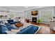 Bright living room features a fireplace, hardwood floors, large windows, and an open layout, perfect for Gathering gatherings at 12214 Bonny Oaks Dr, Cornelius, NC 28031