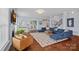 Bright living room features a fireplace, hardwood floors, large windows, and an open layout, perfect for Gathering gatherings at 12214 Bonny Oaks Dr, Cornelius, NC 28031
