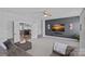 Comfortable living room features a modern accent wall with mounted TV and a plush seating area at 12214 Bonny Oaks Dr, Cornelius, NC 28031