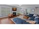 Bright living room features a fireplace, hardwood floors, large windows, and an open layout, perfect for Gathering gatherings at 12214 Bonny Oaks Dr, Cornelius, NC 28031