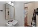 Stylish powder room with pedestal sink, gold-framed mirror, and neutral decor at 12214 Bonny Oaks Dr, Cornelius, NC 28031