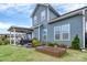 Backyard featuring a covered patio with an outdoor kitchen and small garden at 1230 Therns Ferry Dr, Fort Mill, SC 29708