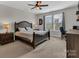Cozy bedroom featuring a ceiling fan, large window, and comfortable workspace at 1230 Therns Ferry Dr, Fort Mill, SC 29708