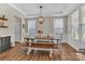 Bright dining area with tray ceiling, modern chandelier, wood flooring, and plenty of natural light at 1230 Therns Ferry Dr, Fort Mill, SC 29708