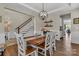 Elegant dining area with chandelier, wood flooring, and seamless flow into the adjacent kitchen area at 1230 Therns Ferry Dr, Fort Mill, SC 29708