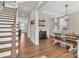 Open dining area with stylish light fixture, wooden table and bench, and easy access to the staircase at 1230 Therns Ferry Dr, Fort Mill, SC 29708