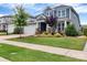 Charming two-story home with a manicured lawn, mature trees, and a welcoming front porch area at 1230 Therns Ferry Dr, Fort Mill, SC 29708