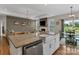 Open kitchen with granite countertops, stainless steel appliances, and a view into the living room and dining area at 1230 Therns Ferry Dr, Fort Mill, SC 29708