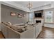 Living room showcases a fireplace, large sectional couch, and ample natural light from the large windows at 1230 Therns Ferry Dr, Fort Mill, SC 29708