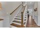 Staircase with wooden handrail and white risers, leading to the upper level of the home. Hardwood floors at 1230 Therns Ferry Dr, Fort Mill, SC 29708