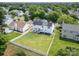 Aerial view showcasing a home with solar panels, a spacious backyard, and a surrounding residential neighborhood at 12303 Shadow Ridge Ln, Charlotte, NC 28273