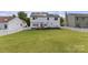 Spacious backyard featuring a lush green lawn, a white picket fence, and a view of the home's solar panels at 12303 Shadow Ridge Ln, Charlotte, NC 28273