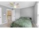 Bedroom with patterned bedspread and neutral gray walls, showcasing an open doorway at 12303 Shadow Ridge Ln, Charlotte, NC 28273