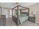 Comfortable primary bedroom with a four-poster bed and ensuite bathroom entrance at 12303 Shadow Ridge Ln, Charlotte, NC 28273