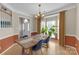 Traditional dining room showcasing a wood table, blue chairs, chandelier, and bay window at 12303 Shadow Ridge Ln, Charlotte, NC 28273