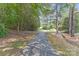 Long driveway leading to the house, surrounded by lush trees and greenery at 12303 Shadow Ridge Ln, Charlotte, NC 28273